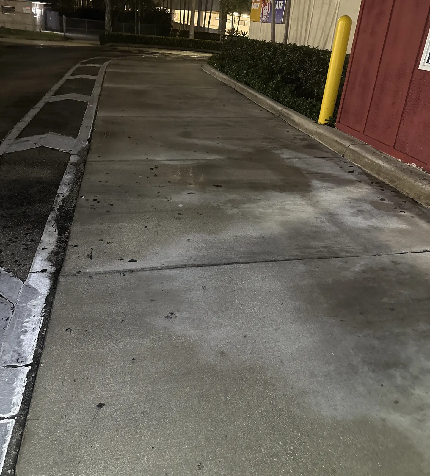 Concrete walkway at a retail property after surface cleaning, North Miami
